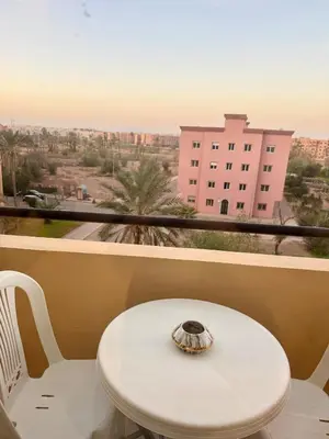 a white table and chairs on a balcony with a view at Modern charm in Marrakesh for a relaxing stay in Marrakech