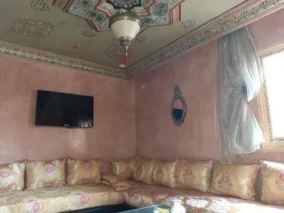 a living room with a couch and a tv on the ceiling at Appartement centre de Marrakech in Marrakech
