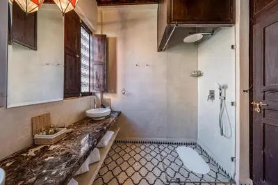 a bathroom with a sink and a toilet and a shower at Riad Royal Koubba in Marrakech