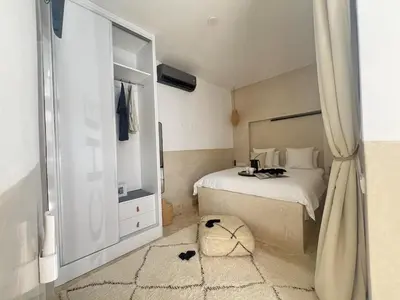a bedroom with a bed and a large mirror at Riad Manoury Marrakech - privates Boutique-Hotel für 6 in Marrakech