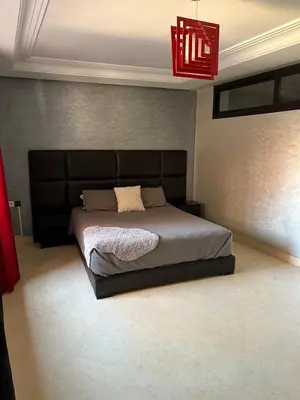 a bedroom with a bed and a red chandelier at Riad Arfoud Duplex Fully Equiped in Marrakech