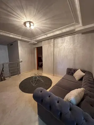 a living room with a couch and a rug at Riad Arfoud Duplex Fully Equiped in Marrakech