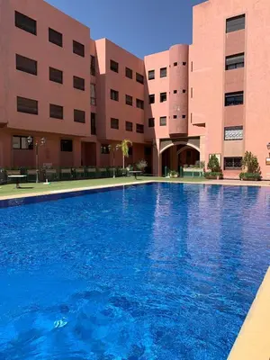a large swimming pool in front of a building at Riad Arfoud Duplex Fully Equiped in Marrakech