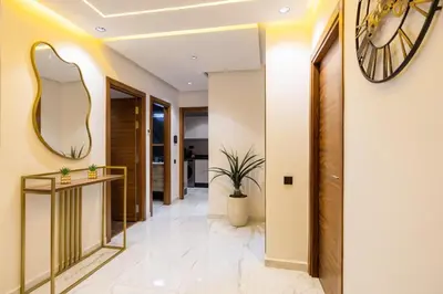 a hallway with a large clock on the wall at Moderne appart Gueliz 3 ch parking Carrefour in Marrakech