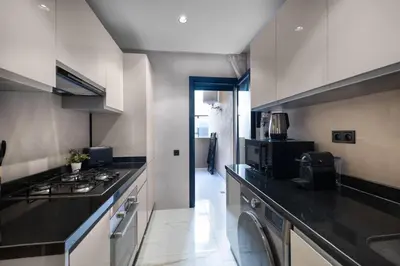 a kitchen with a stove and a counter top at Moderne appart Gueliz 3 ch parking Carrefour in Marrakech