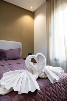 a swan made out of towels on a bed at Moderne appart Gueliz 3 ch parking Carrefour in Marrakech