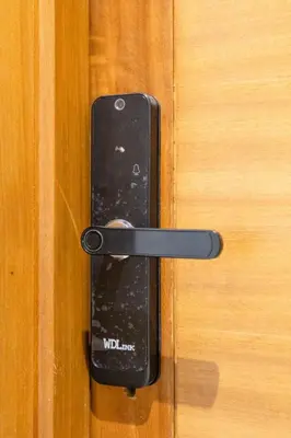 a black door handle on a wooden door at Moderne appart Gueliz 3 ch parking Carrefour in Marrakech