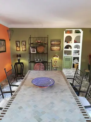 a dining room with a table with a plate on it at Dar Ahlam in Marrakech