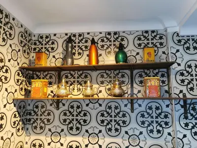 a room with shelves with differentiatesiatesiatesiatesiatesiatesktop at Dar Ahlam in Marrakech