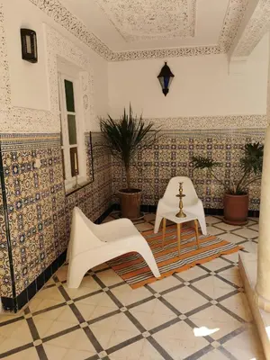 a room with a table and two chairs in it at Dar Ahlam in Marrakech