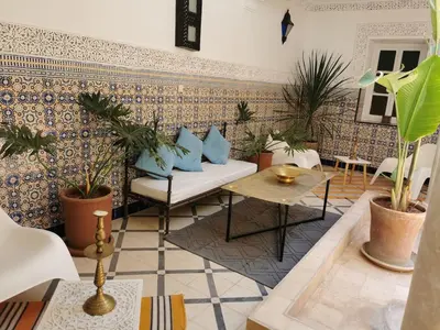 a living room with a couch and some plants at Dar Ahlam in Marrakech