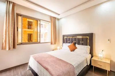 a bedroom with a large bed and a window at comfortable equipped apartment in Marrakech