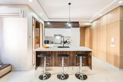 a kitchen with a island with bar stools at comfortable equipped apartment in Marrakech