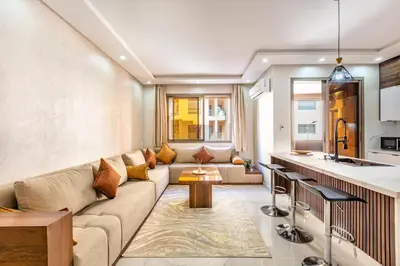 a living room with a couch and a kitchen at comfortable equipped apartment in Marrakech