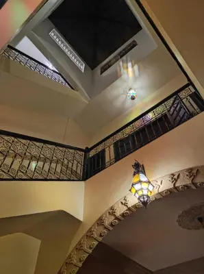 a ceiling with stained glass windows and a light fixture at Riad Zellige 95 in Marrakech