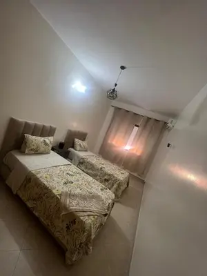 a bedroom with two beds and a window at Appartement Marrakech in Marrakech