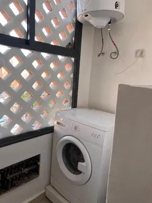 a washer and dryer in a room with a wall at Appartement Marrakech in Marrakech