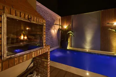 a swimming pool in a house with a fireplace at luxueux duplex avec piscine privée in Marrakech