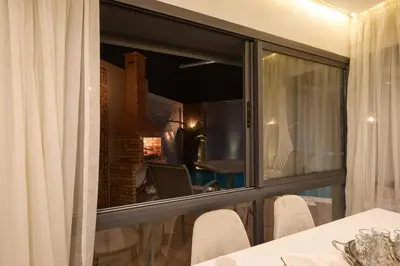 a room with a window with a table and a laptop at luxueux duplex avec piscine privée in Marrakech