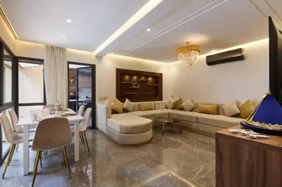 a living room with a couch and a table at luxueux duplex avec piscine privée in Marrakech