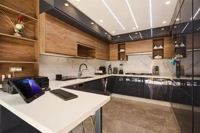 a kitchen with a desk with a laptop on a counter at Luxurious duplex with a private pool in Marrakech