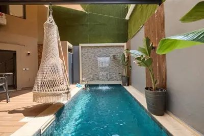 a swimming pool with a hammock in a house at Luxurious duplex with a private pool in Marrakech