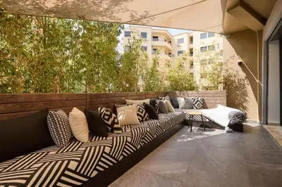 a couch on a patio with pillows on it at Luxurious duplex with a private pool in Marrakech