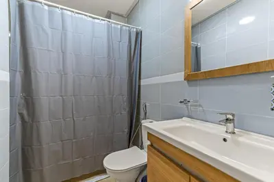 a bathroom with a sink and a toilet and a mirror at Massira Social Living in Marrakech