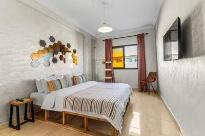 a bedroom with a bed and a television in it at Massira Social Living in Marrakech