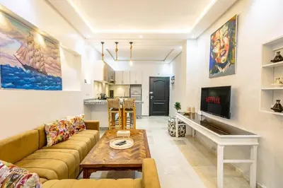 a living room with a couch and a table at Cosy appartement bed 1 in Marrakech