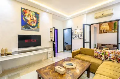 a living room with a couch and a table at Cosy appartement bed 1 in Marrakech