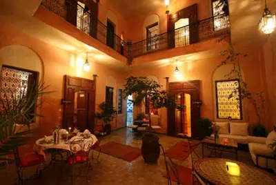a large living room with a table and chairs at Riad Todra in Marrakech