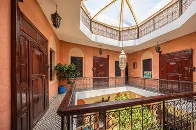 an indoor tub in a room with a balcony at Riad Todra in Marrakech