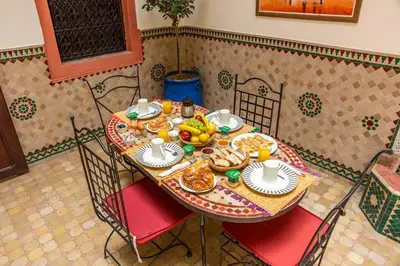 a table with breakfast food on it in a room at Riad Todra in Marrakech