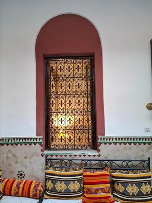 a window in a room with colorful pillows at Riad Todra in Marrakech