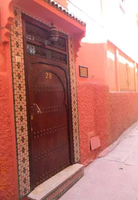 a door with the number on the side of a building at Riad Todra in Marrakech
