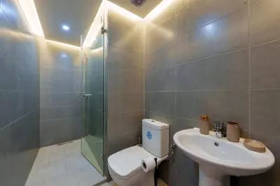 a bathroom with a toilet and a sink and a shower at family pool apartment in Marrakech