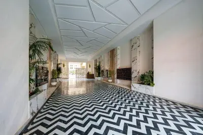 a hallway with a black and white checkered floor at family pool apartment in Marrakech