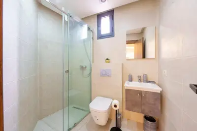 a bathroom with a shower and a toilet and a sink at family pool apartment in Marrakech