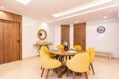 a dining room with a wooden table and yellow chairs at family pool apartment in Marrakech