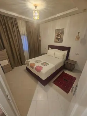 a bedroom with a bed and a chandelier at the Heart of Marrakech Your Private Oasis in Marrakech