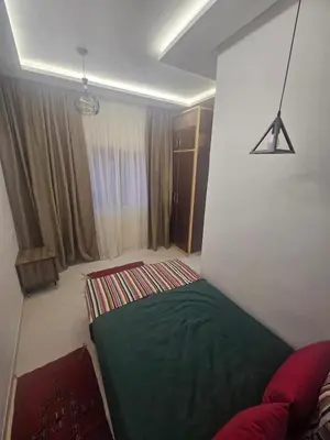 a bedroom with a green bed in a room at the Heart of Marrakech Your Private Oasis in Marrakech