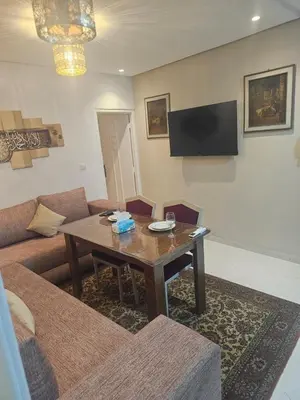 a living room with a table and a couch at the Heart of Marrakech Your Private Oasis in Marrakech