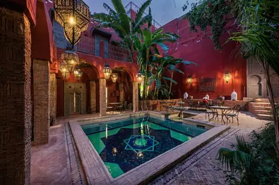 an indoor pool in a courtyard with a house at Riad Les Jardins d'Henia in Marrakech
