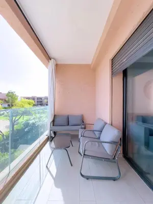 a living room with two couches and a large window at Noria Golf Elegance Pool with View in Marrakech