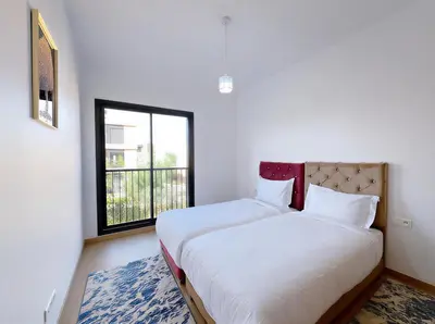 a bedroom with a large bed with a window at Noria Golf Elegance Pool with View in Marrakech