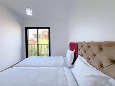 a bedroom with two beds and a window at Noria Golf Elegance Pool with View in Marrakech
