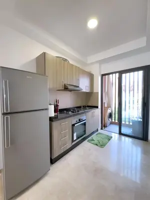 a kitchen with a refrigerator and a stove at Noria Golf Elegance Pool with View in Marrakech
