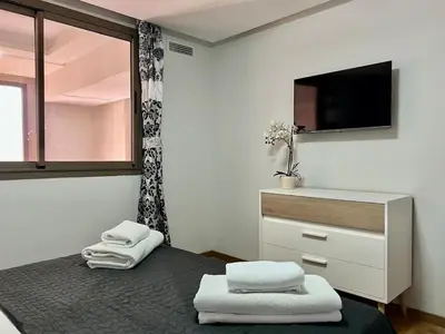 a bedroom with a bed with a tv and a dresser at Beautiful Duplex Fast Wi-Fi Terrace Pool in Marrakech