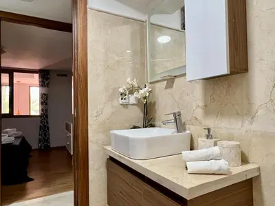 a bathroom with a sink and a counter with towels at Beautiful Duplex Fast Wi-Fi Terrace Pool in Marrakech